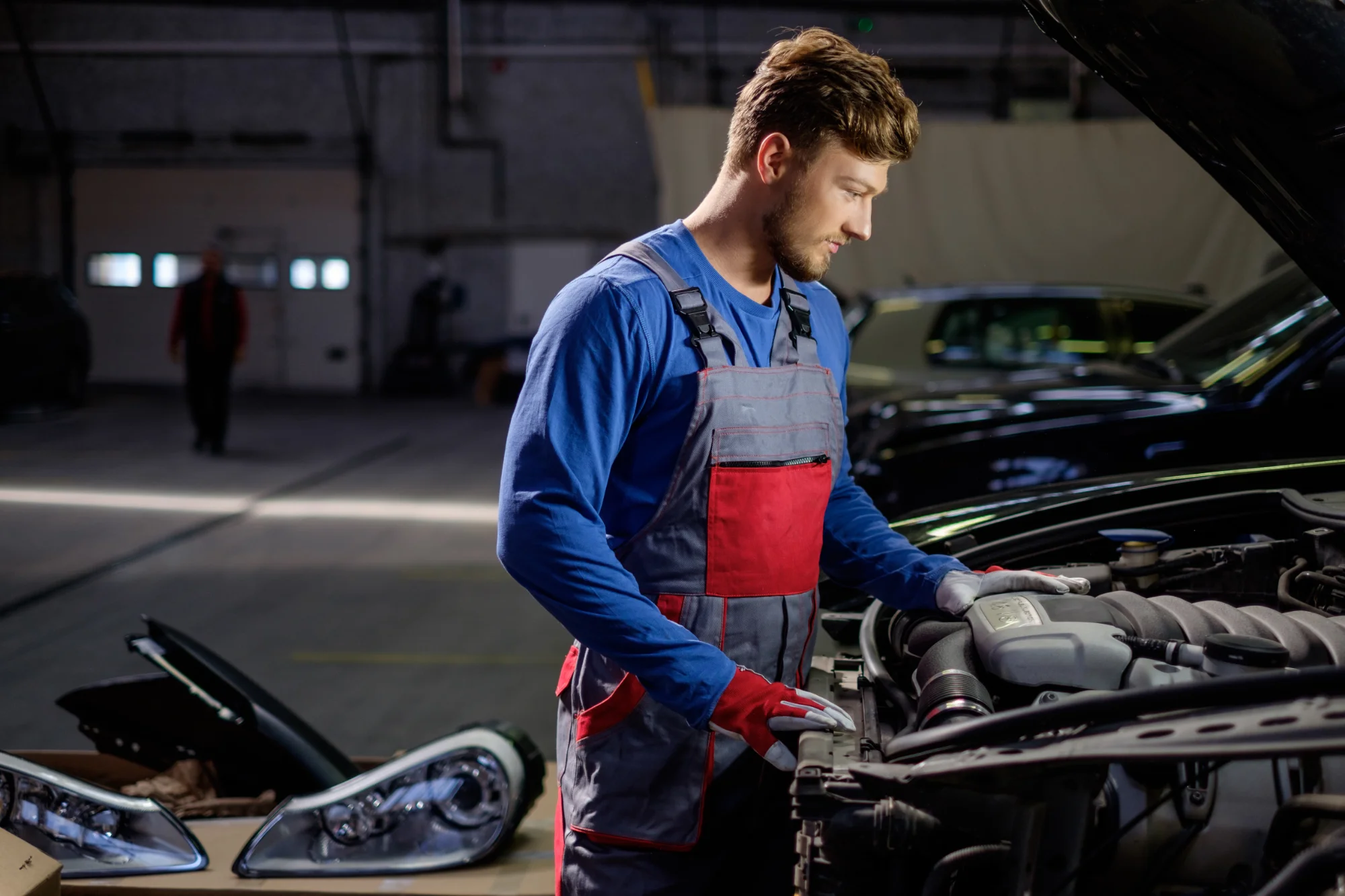man-working-on-car-engine-in-auto-repair-2026-09-24-04-14-39-utc